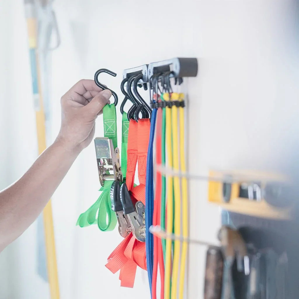 AV1 Hook Rail mounted in a garage with cargo straps hanging neatly organized