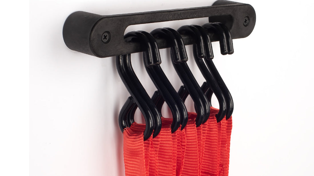 Red tie-down straps hanging by their S-hooks on an AV1 Hook Rail