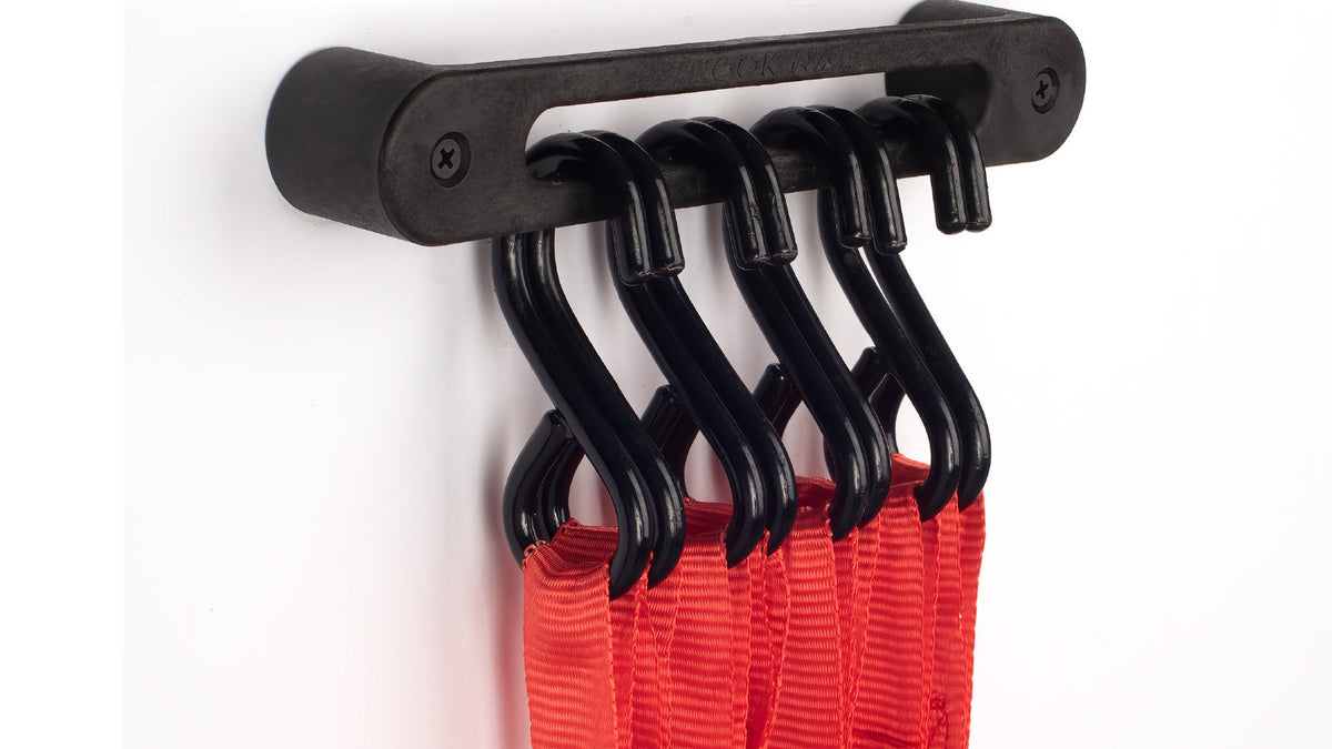Red tie-down straps hanging by their S-hooks on an AV1 Hook Rail